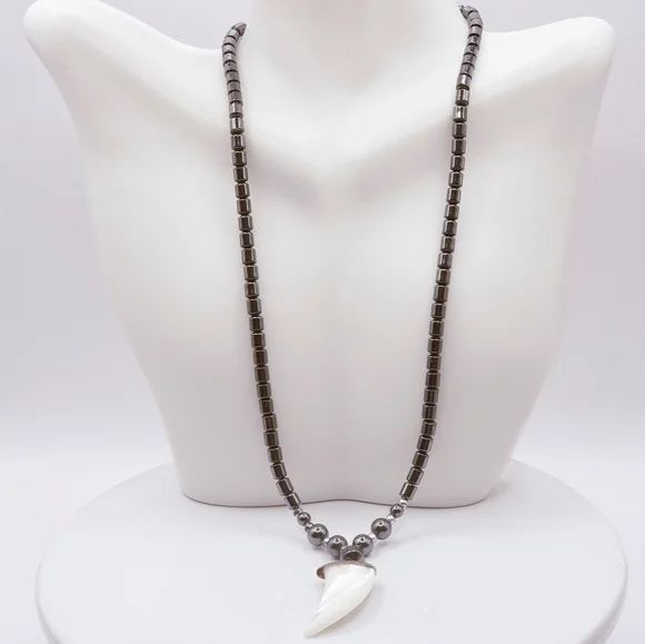Hematite With Carved Mother Of Pearl Ivory Claw Pendant Necklace